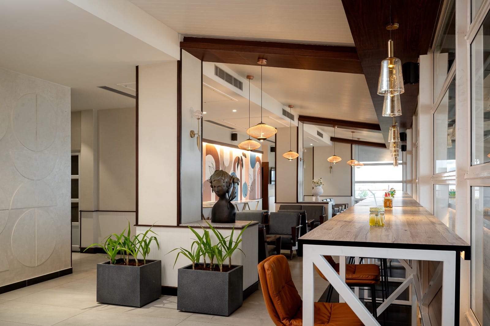 Cafe interior with pendant lighting and sea-facing windows